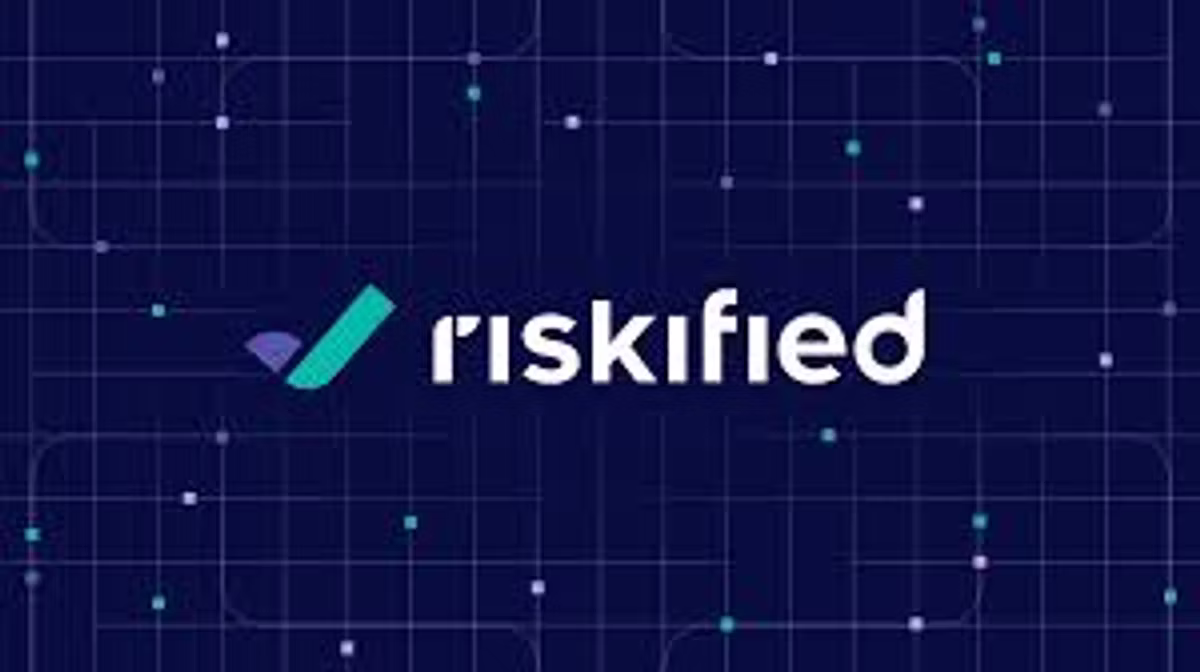 The Riskified logo in white on a dark navy background patterned with faint circuit lines and dots.