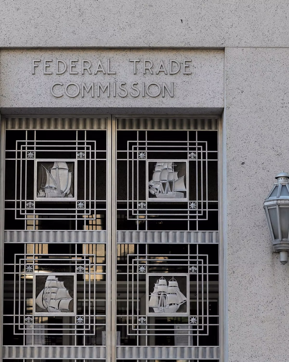 Federal Trade Commission building entrance with art deco ship window grilles and a stone facade.